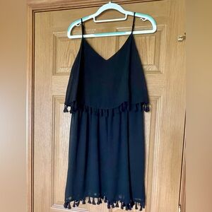 Short black played dress with tassels. Size medium